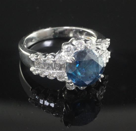 An 18ct white gold and single stone fancy colour diamond ring with round cut white diamond border.